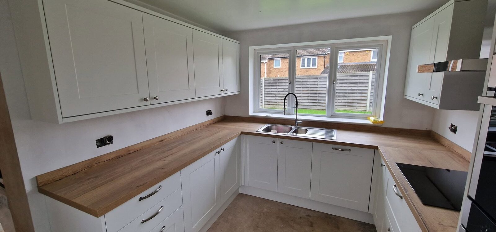 Completed Howdens Chelford White kitchen with Aged Oak Effect worktops