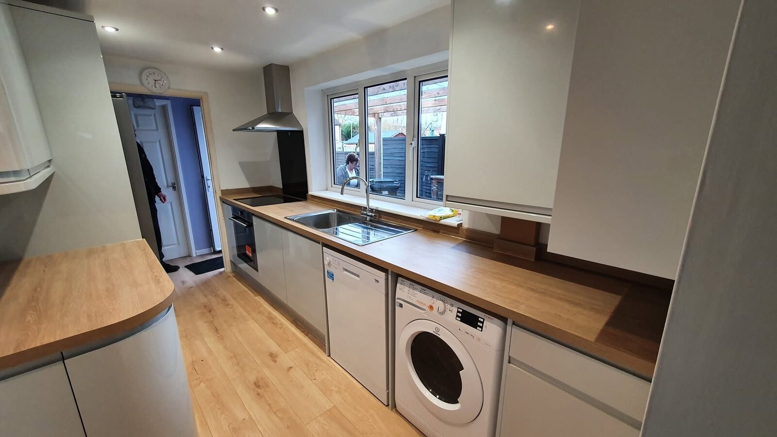 Completed Gloss Dove Grey kitchen with Linear Oak Effect worktops and matching upstands