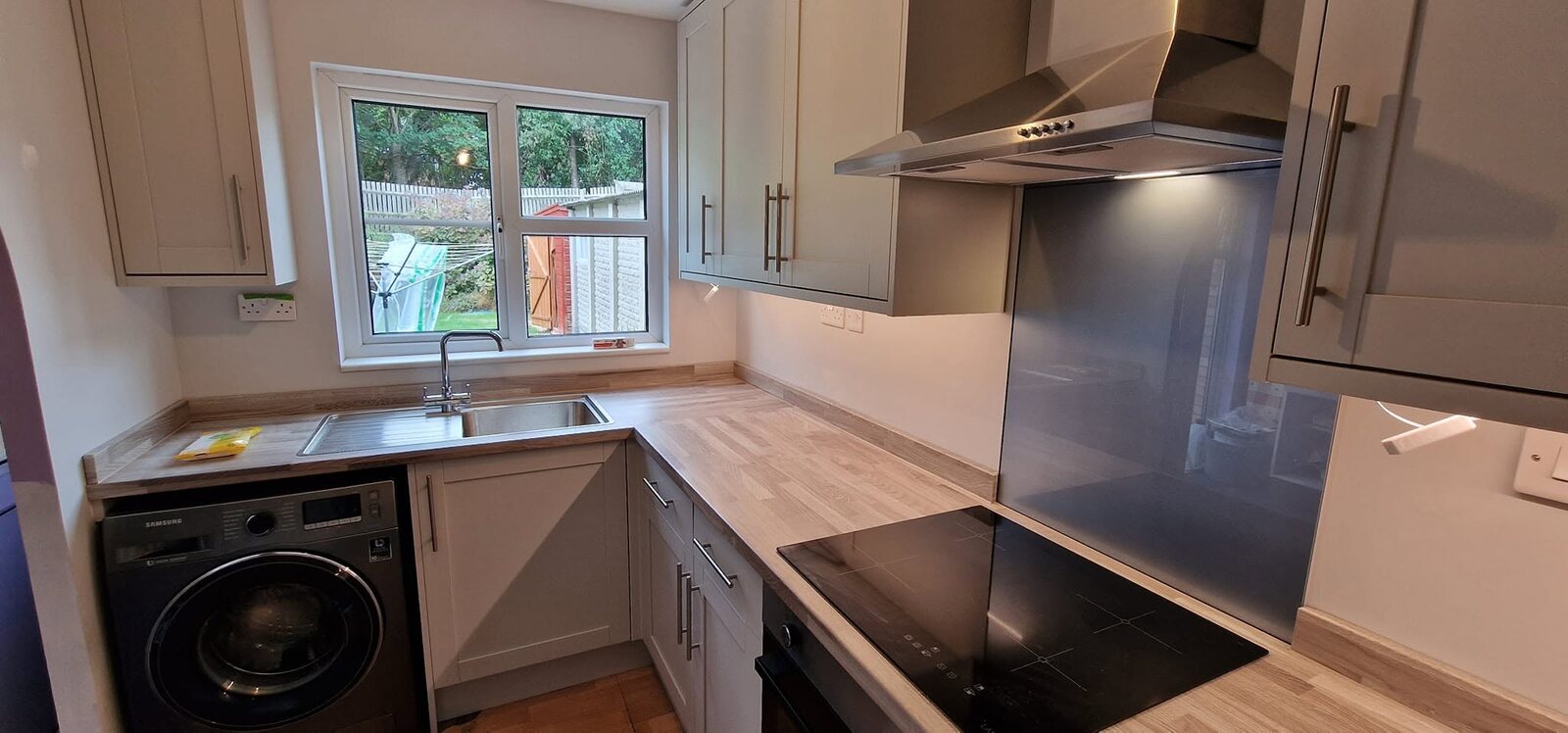Completed Howdens Witney Dove Grey kitchen with extra-tall wall units