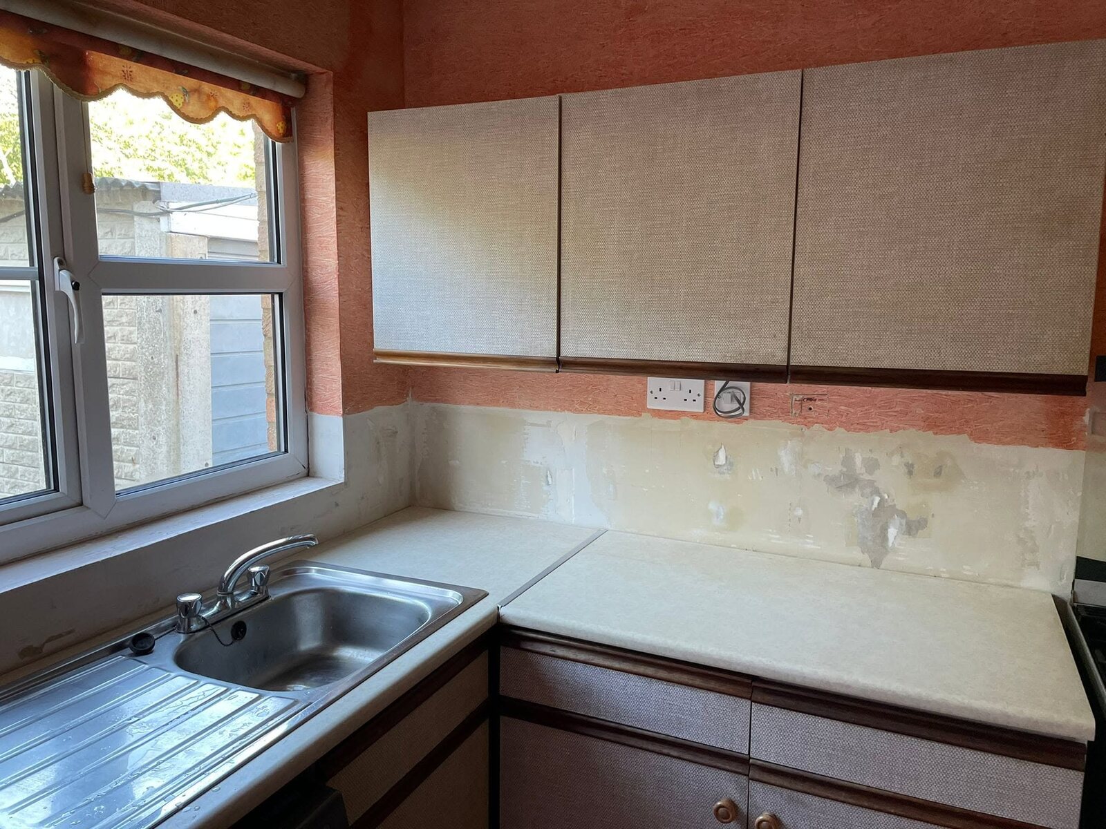 Small kitchen before renovation, sink and wall-unit side