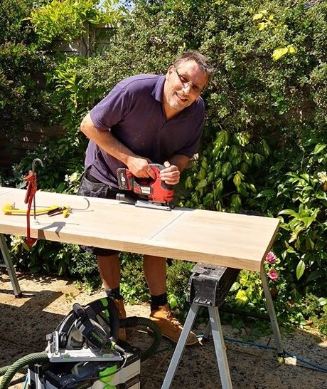 Tony from Stratton Kitchen Fitters cutting a kitchen worktop